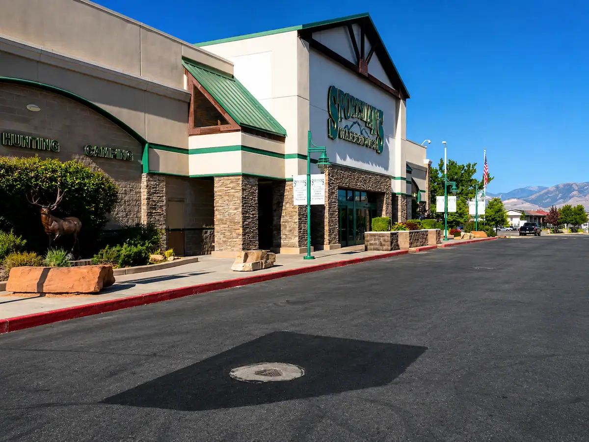 Commercial asphalt patching repair completed near Sportsman's Warehouse in a Utah retail parking lot.