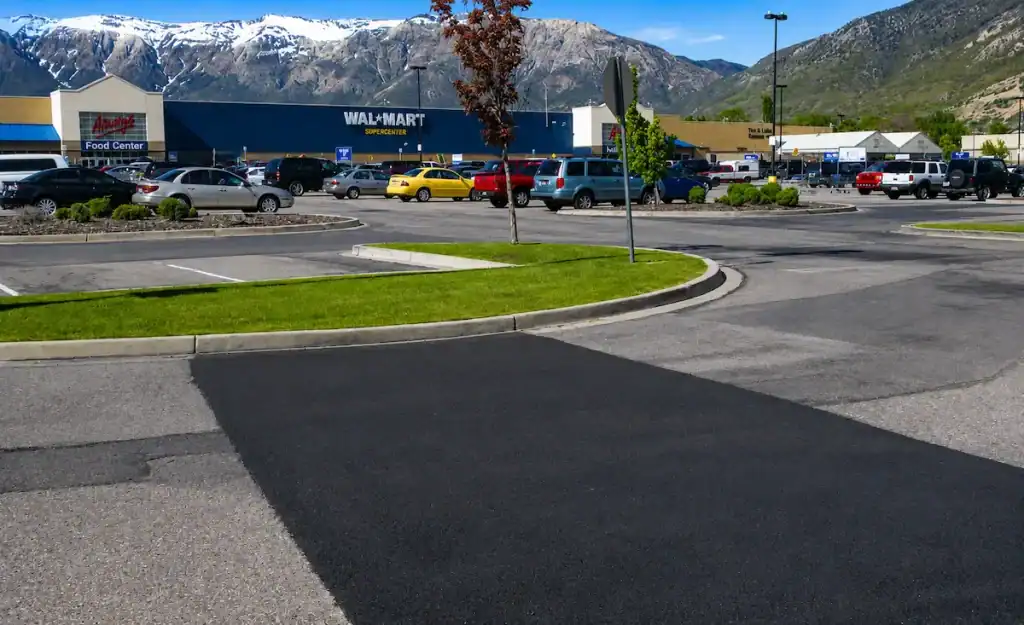 Commercial asphalt patching repair completed in a Utah shopping center parking lot