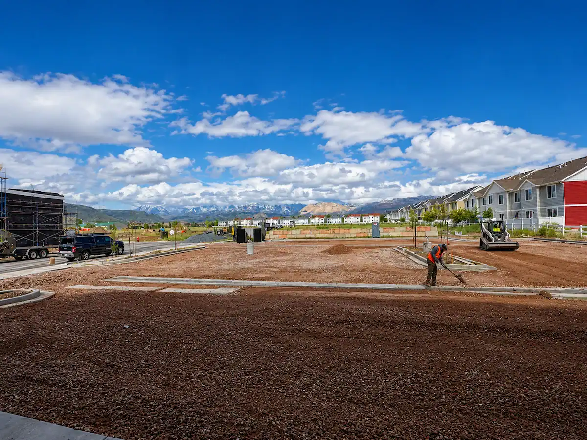 Commercial finish grading project in Utah with construction crews preparing a site for paving and development.
