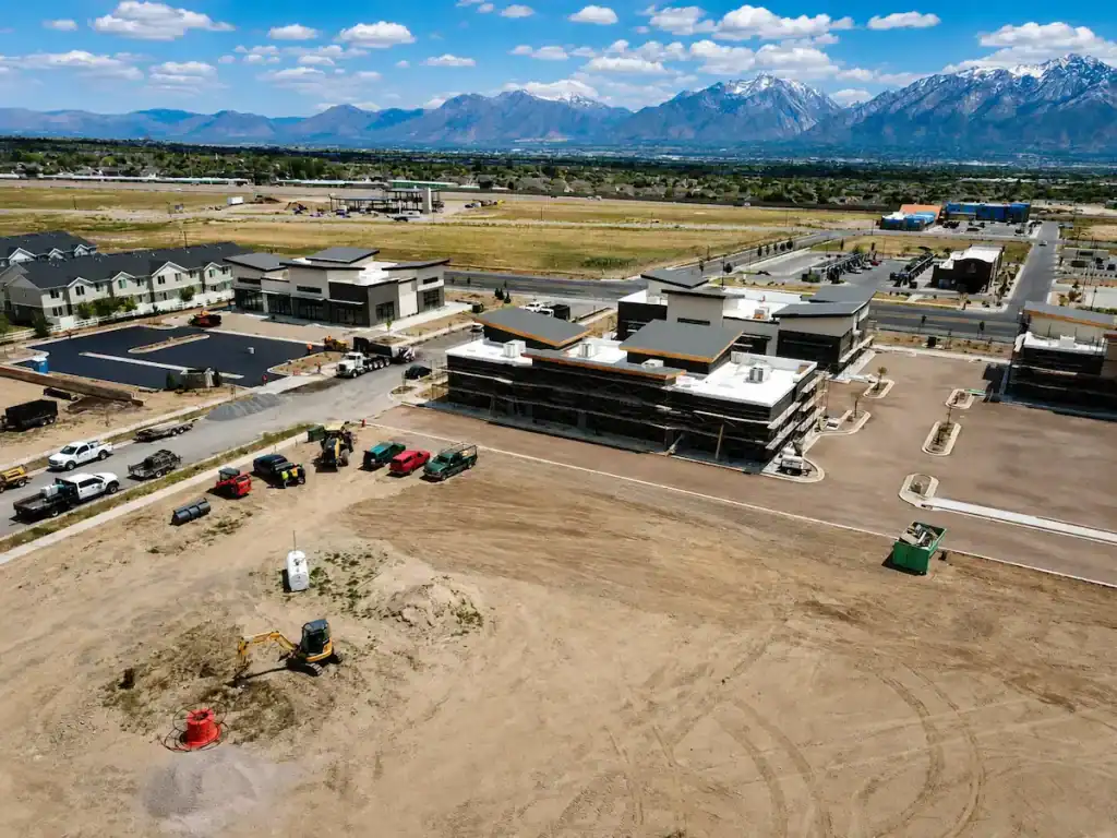 Commercial site grading and land preparation project in Herriman, Utah with mountain views and construction development.