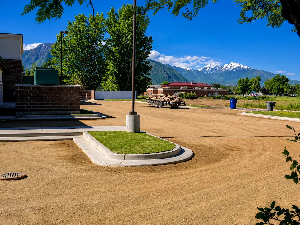 Finished site grading project in Utah showing proper elevations, curb installation, and drainage preparation.