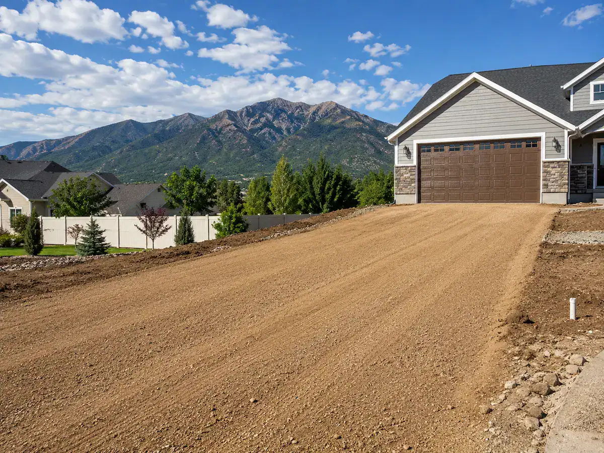 Freshly graded residential driveway in Utah prepared for paving and proper drainage.