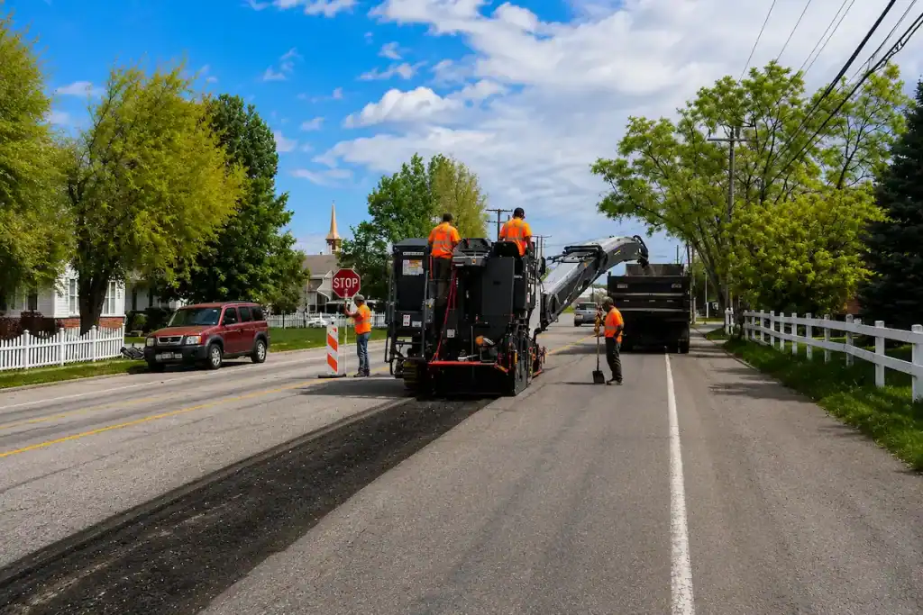 Road milling crew removing worn asphalt from a residential street in Utah