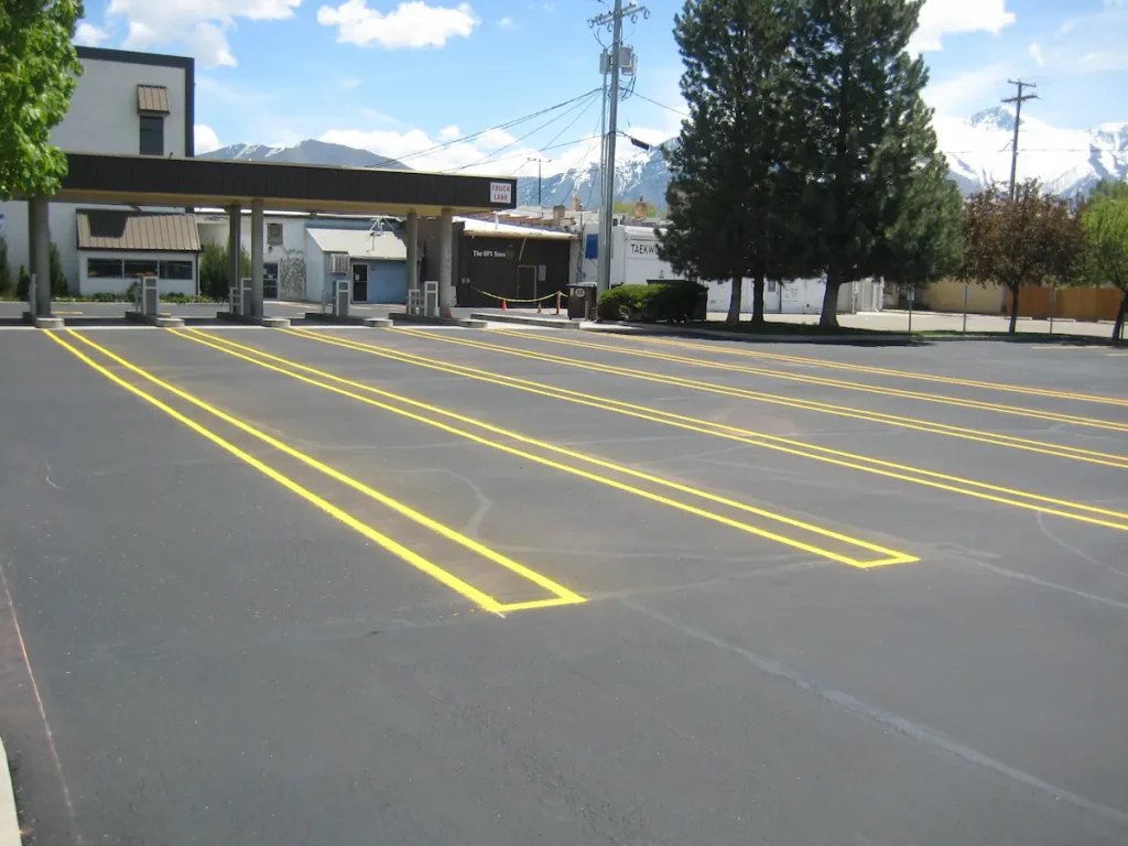 Fresh yellow parking lot lines painted on asphalt in Utah