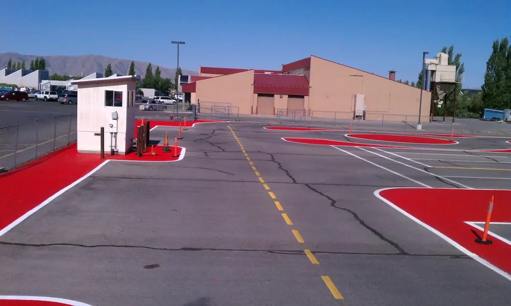 High-visibility red safety zone striping in a Utah commercial parking lot