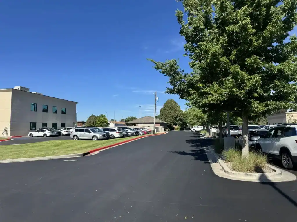 Freshly painted red curbing beside a sealcoated parking lot at Utah Valley Hospital in Provo, Utah.