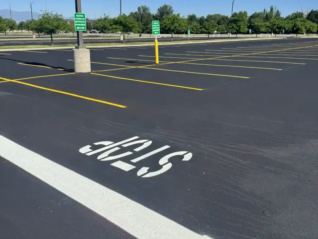 Freshly painted STOP marking and stop bar on sealcoated asphalt at Utah Valley University in Orem, Utah.
