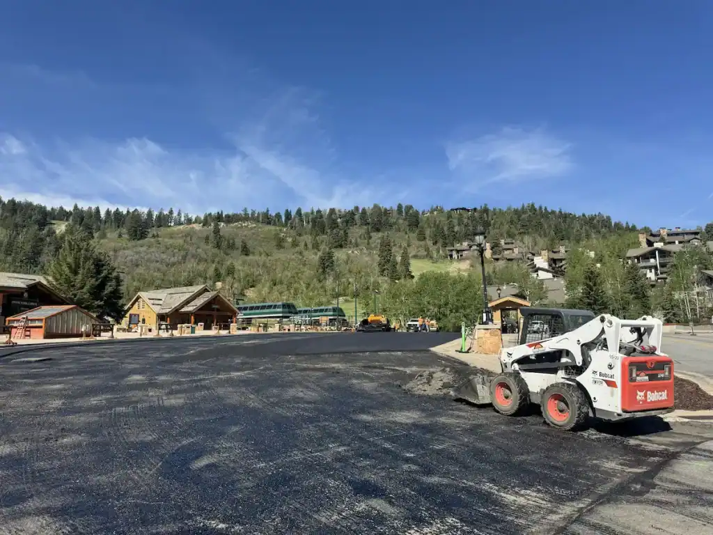 Milled asphalt surface and paving equipment during the Deer Valley Resort asphalt project in Park City, Utah.