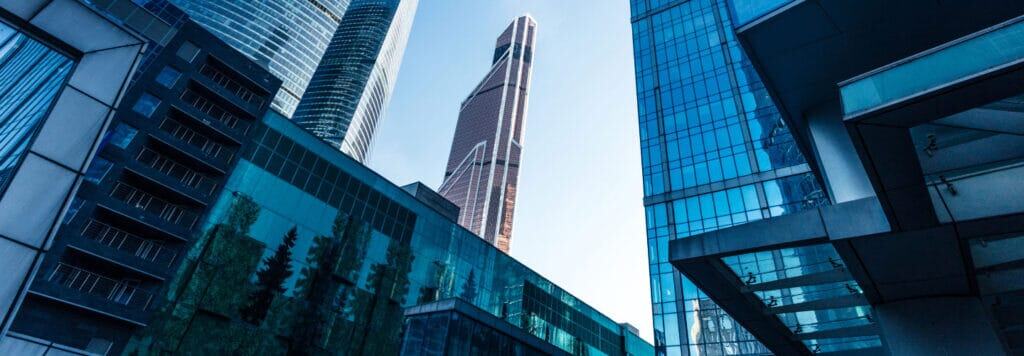 Modern skyscrapers and glass office buildings in a vibrant urban cityscape.