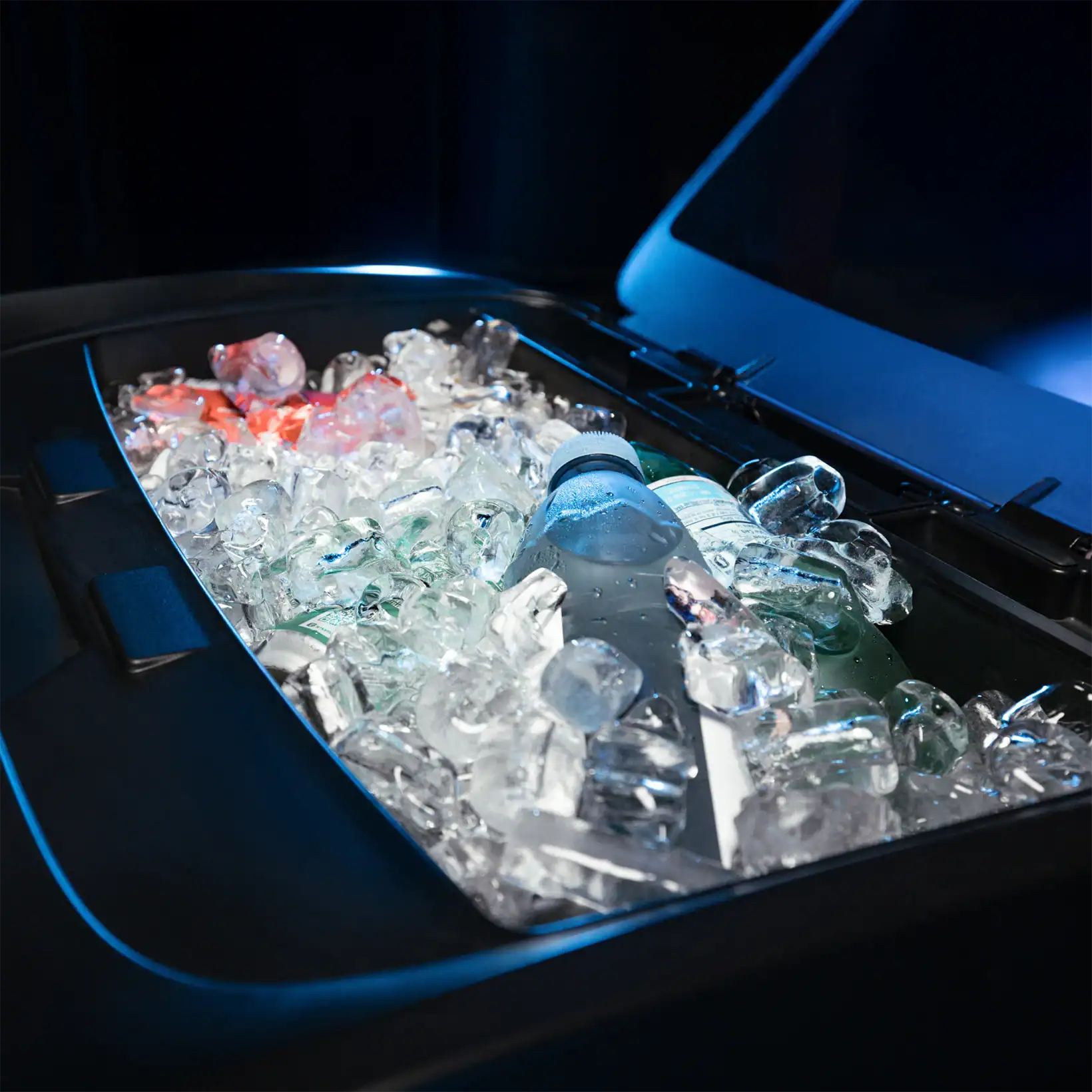 Close-up of Aero’s built-in QuickCool™ Ice Chamber filled with ice and bottled drinks, highlighting its dual function as a cooler and performance enhancer.