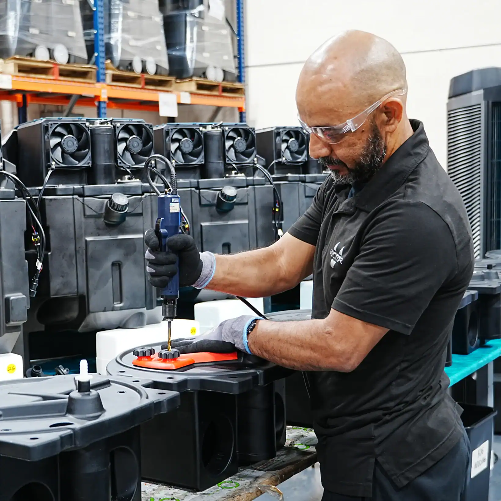 Technician assembling components of the Aero cooling system in a manufacturing facility.