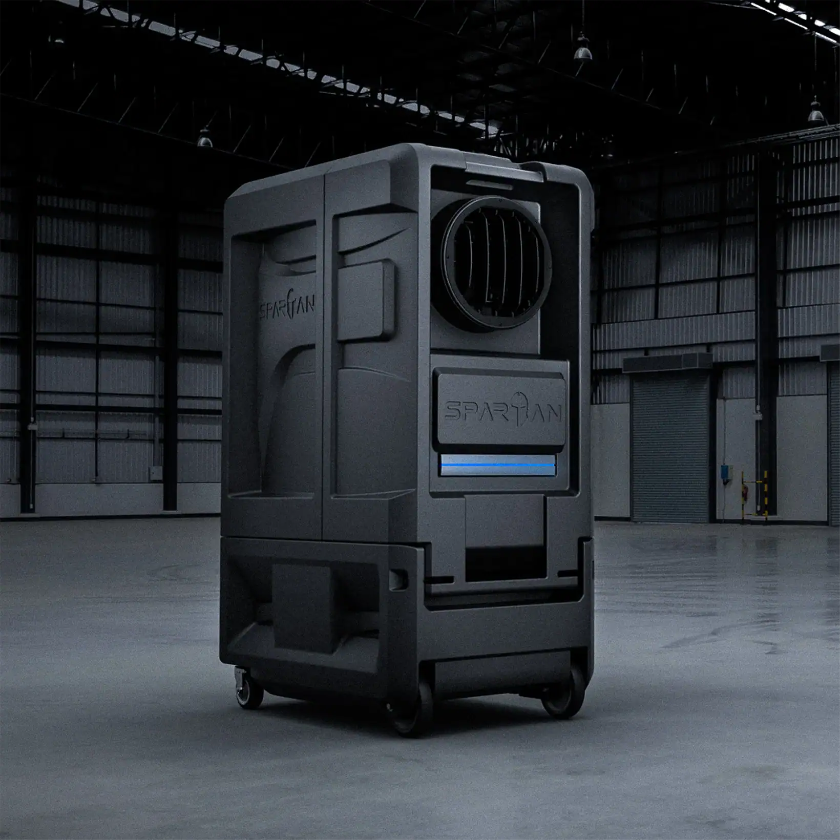 Spartan evaporative cooler positioned inside an industrial warehouse, featuring a rugged, field-ready design with heavy-duty wheels and intelligent airflow system for powerful, reliable cooling.