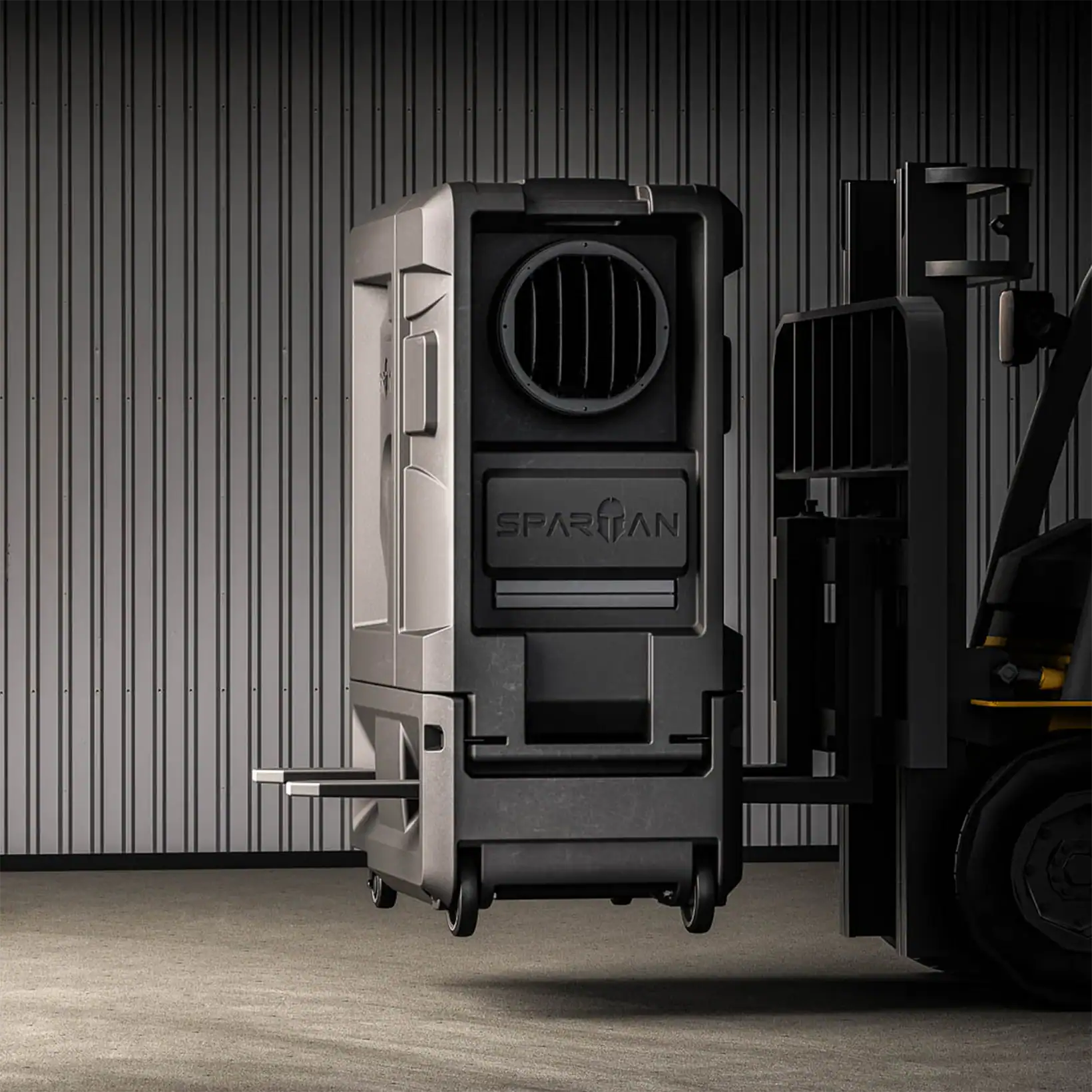 Spartan evaporative cooler lifted by a forklift, demonstrating its integrated forklift slots and rugged industrial design.
