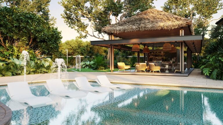 Relaxing pool area at Vida Pinilla with lounge chairs and lush tropical greenery.