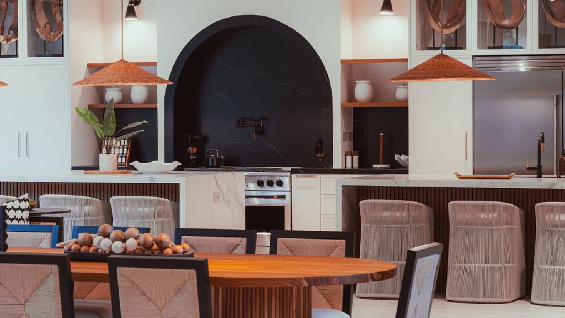 Modern kitchen and dining room interior with wooden accents, stylish decor, and contemporary furniture.