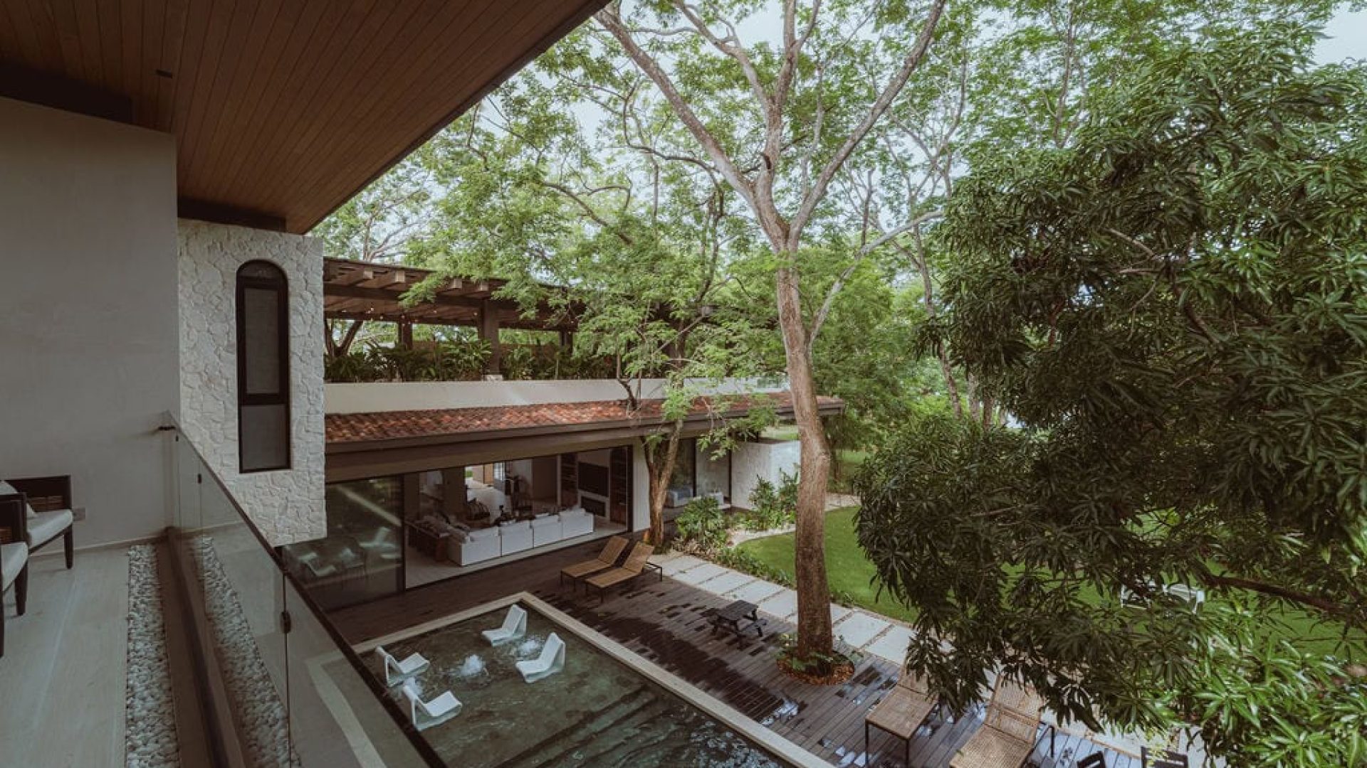 Modern luxury house with outdoor pool and lush greenery in Vida Pinilla estate.