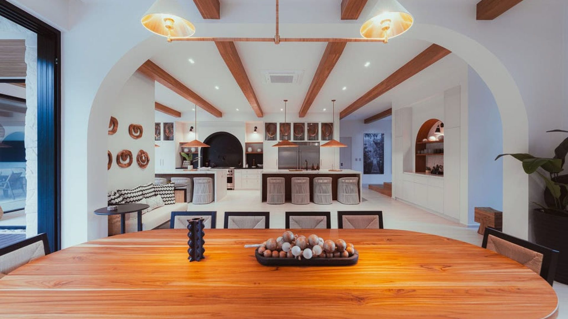 Modern open-concept kitchen and dining area with wooden accents and contemporary decor.
