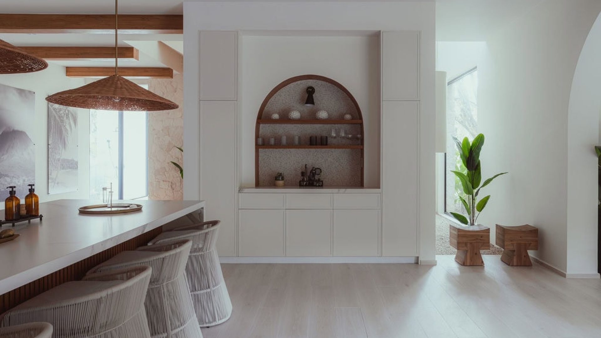 Bright modern kitchen with white cabinetry and natural wood accents at Vida Pinilla.