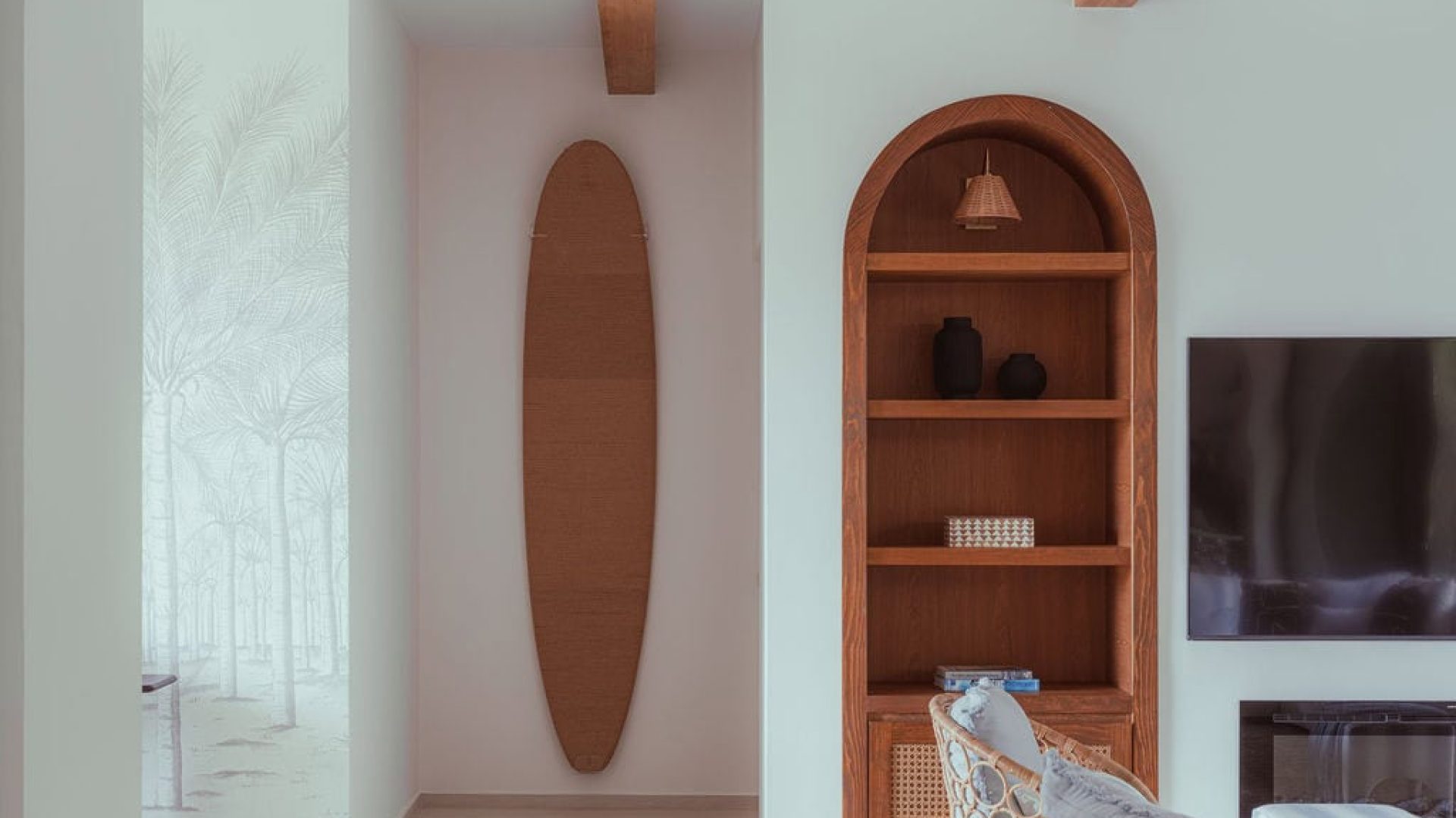 Natural wood decor in modern living room with built-in bookshelf and wall-mounted TV.