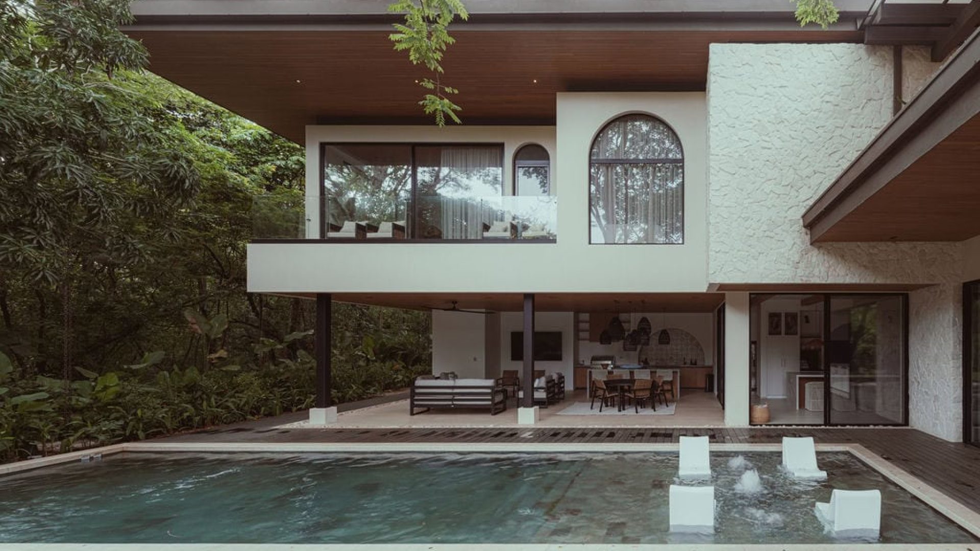 Modern luxury house with outdoor pool and lush greenery at Vida Pinilla estate.