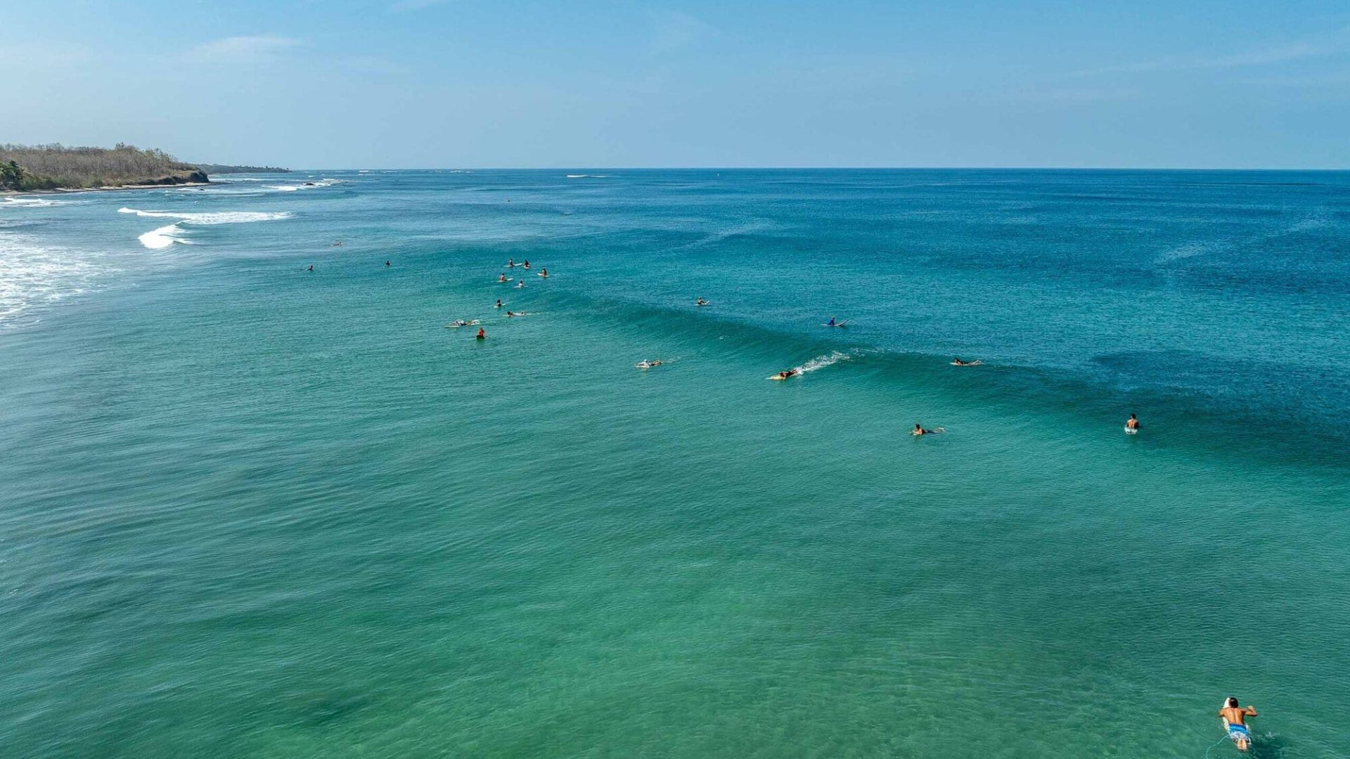Surfing and ocean view at Vida Pinilla beach, Costa Rica, with surfers catching waves.