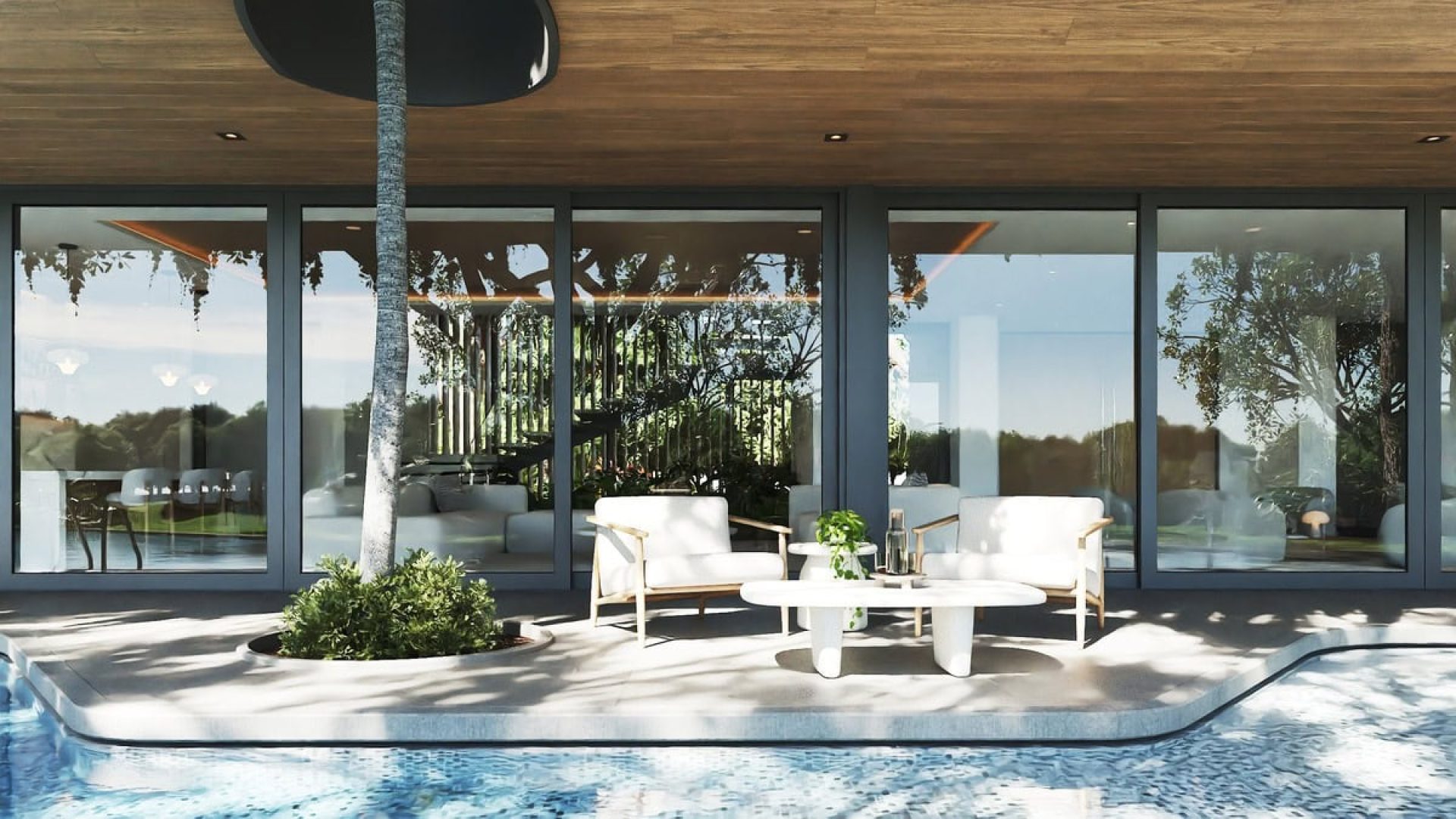 Modern luxury home with poolside seating and large glass windows, outdoor relaxation area.