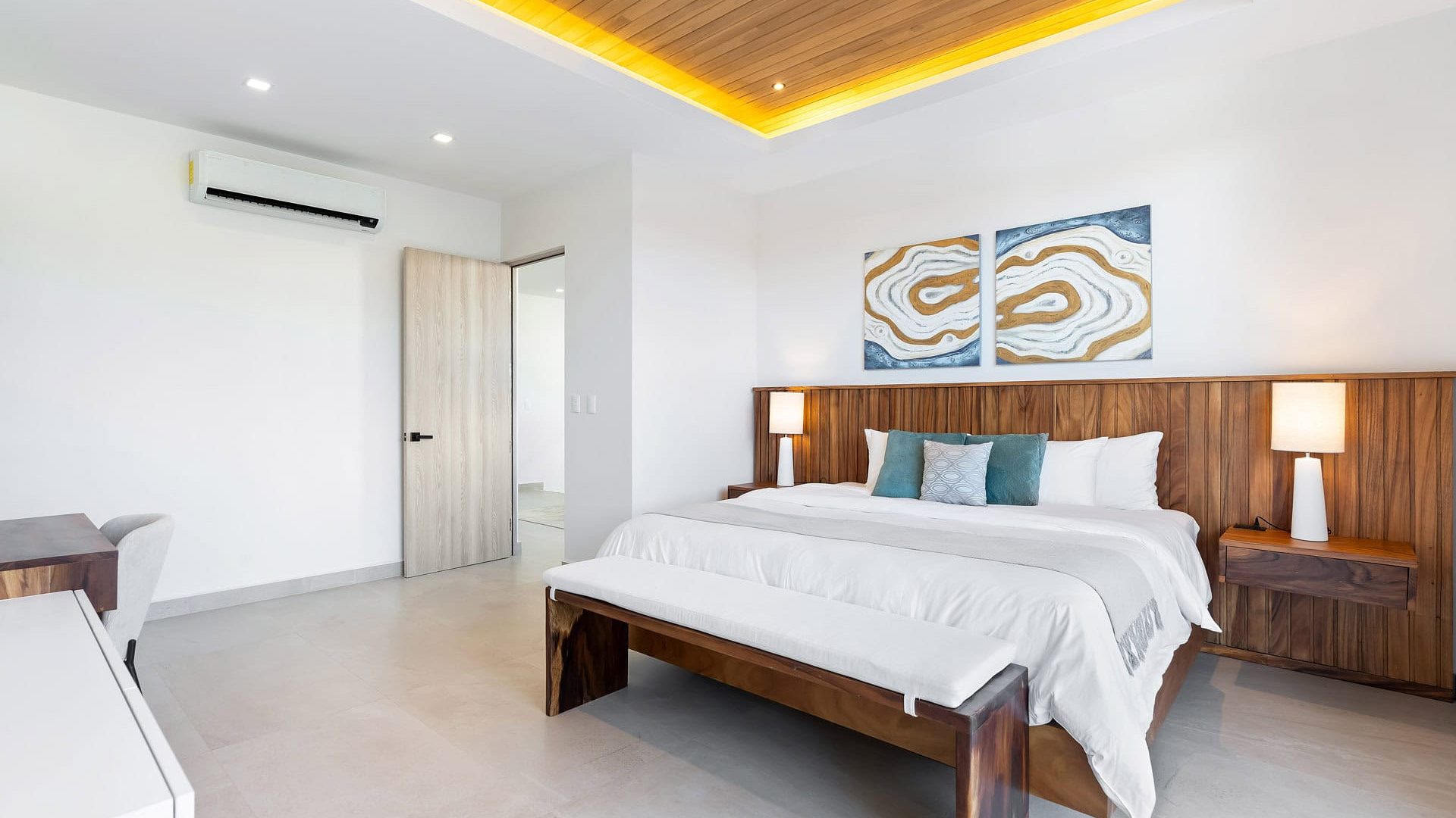 Modern minimalist bedroom with wooden accents and elegant decor for a relaxing stay.