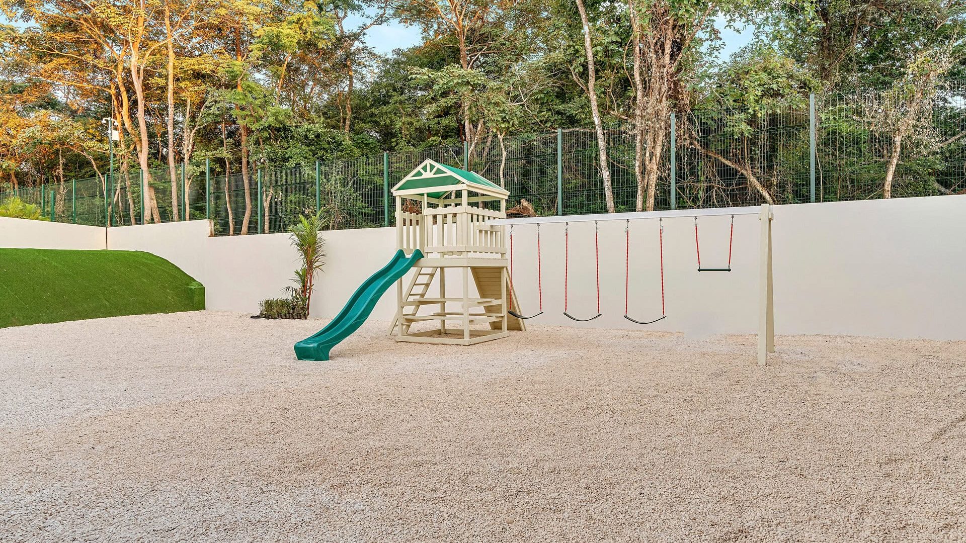 Colorful backyard playground with slide and swings in a private outdoor space.