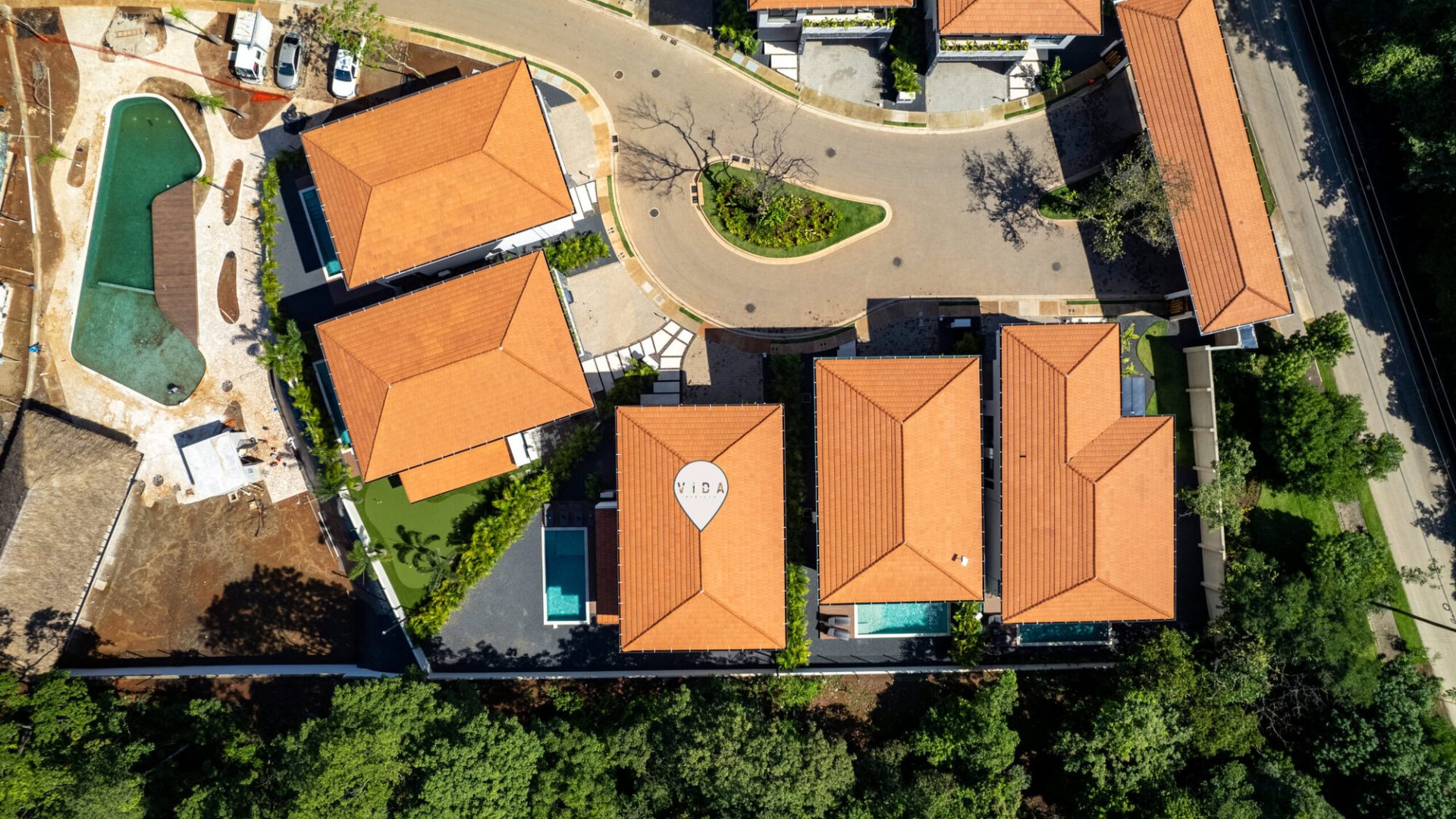 Spacious residential community with red-tile roofs, landscaped gardens, and swimming pools.