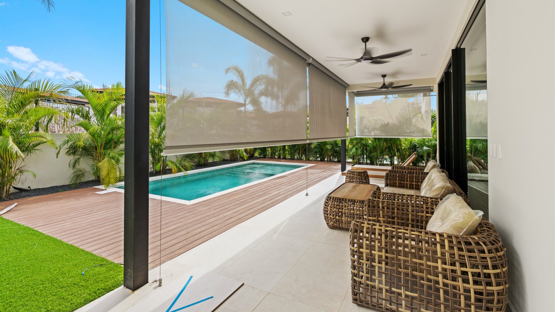 Bright outdoor patio with private pool and lush tropical plants for relaxing and entertaining.