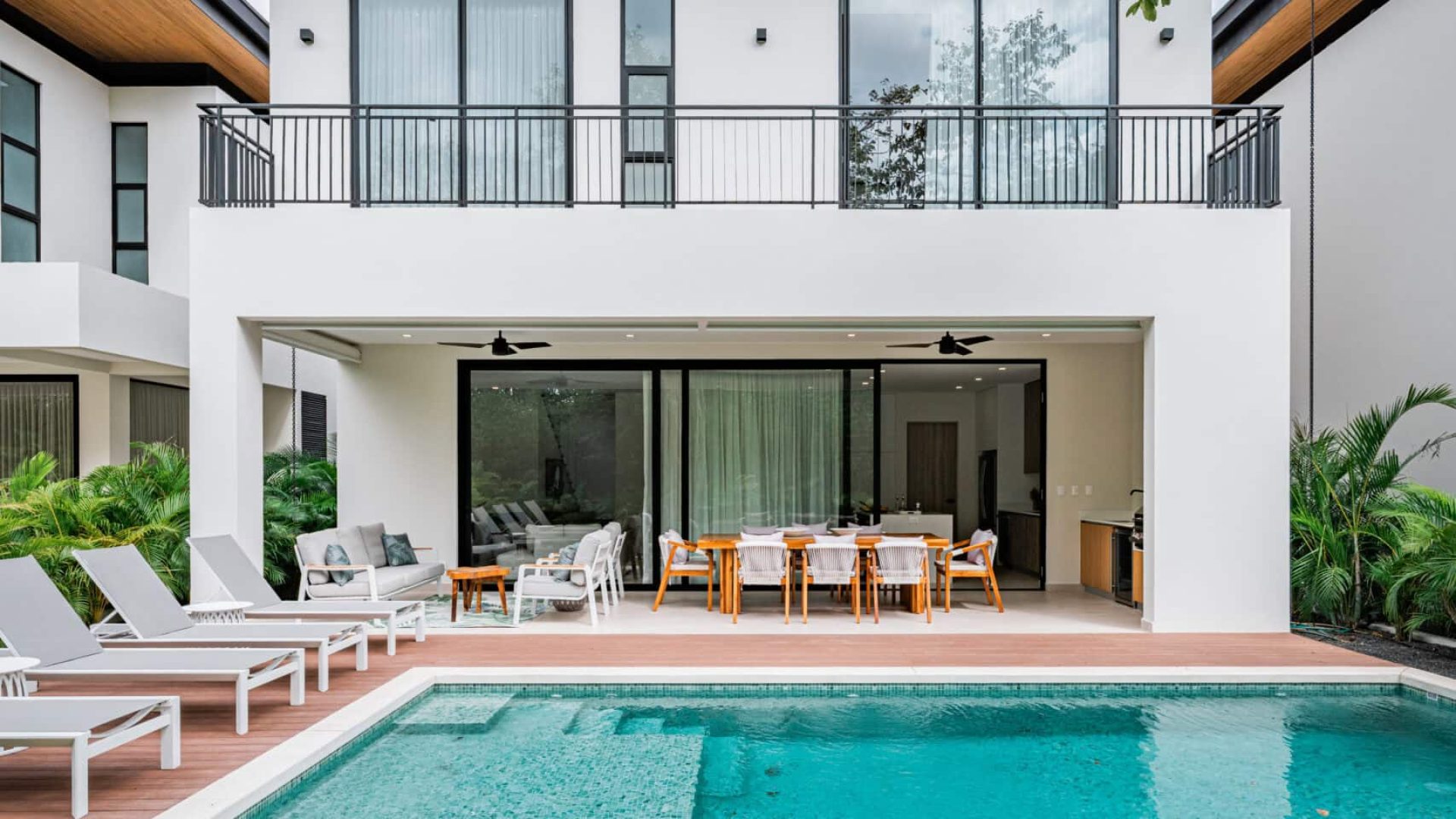 Modern luxury home with private pool, outdoor lounge, and contemporary design.