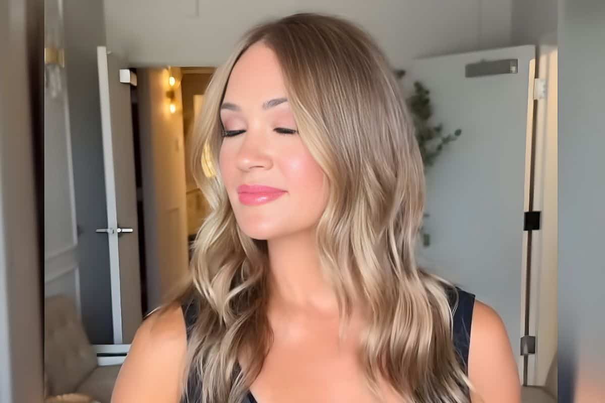 Young woman enjoying music with eyes closed, relaxing at home.