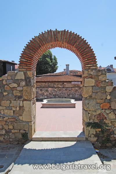 An ancient archway leading to the courtyard of the historic town, showcasing its timeless charm and rich heritage.