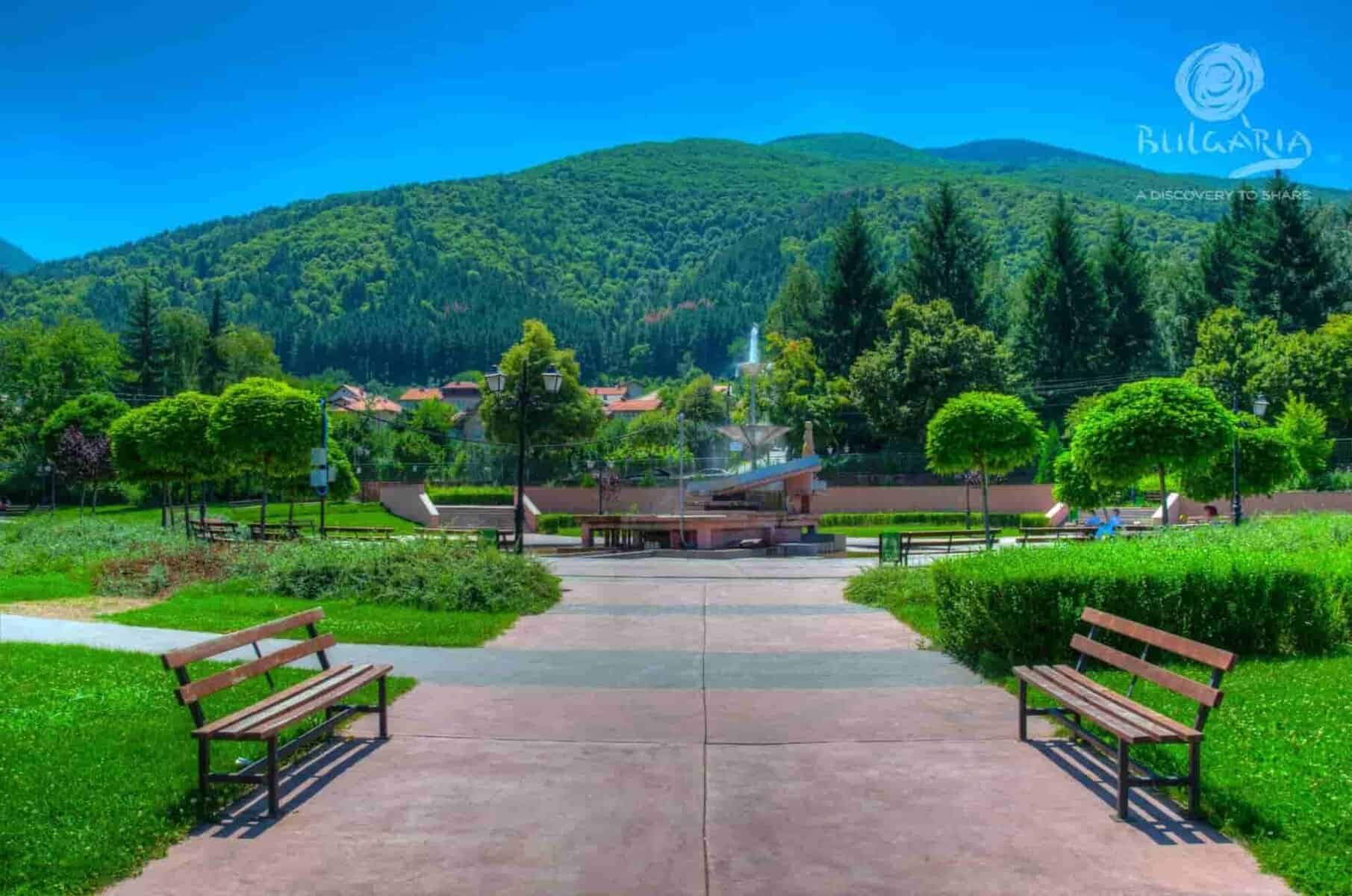 A serene park with benches and a central fountain, providing a peaceful and relaxing atmosphere.