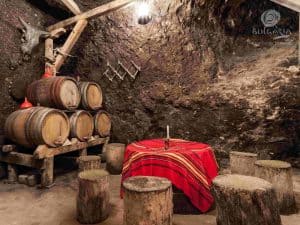 Table with red cloth, set for dinner with elegant silverware and crystal glasses