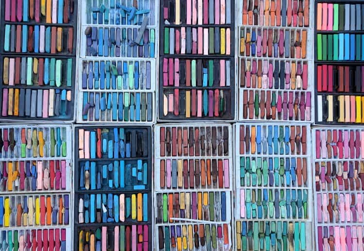 Pastel chalks arranged in colorful sets for art and drawing supplies at Visual Arts Passage.