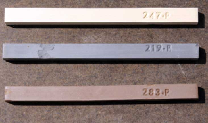 3. Three painted wooden beams with engraved measurements in a close-up shot, highlighting artistic and manufacturing details at Visual Arts Passage.