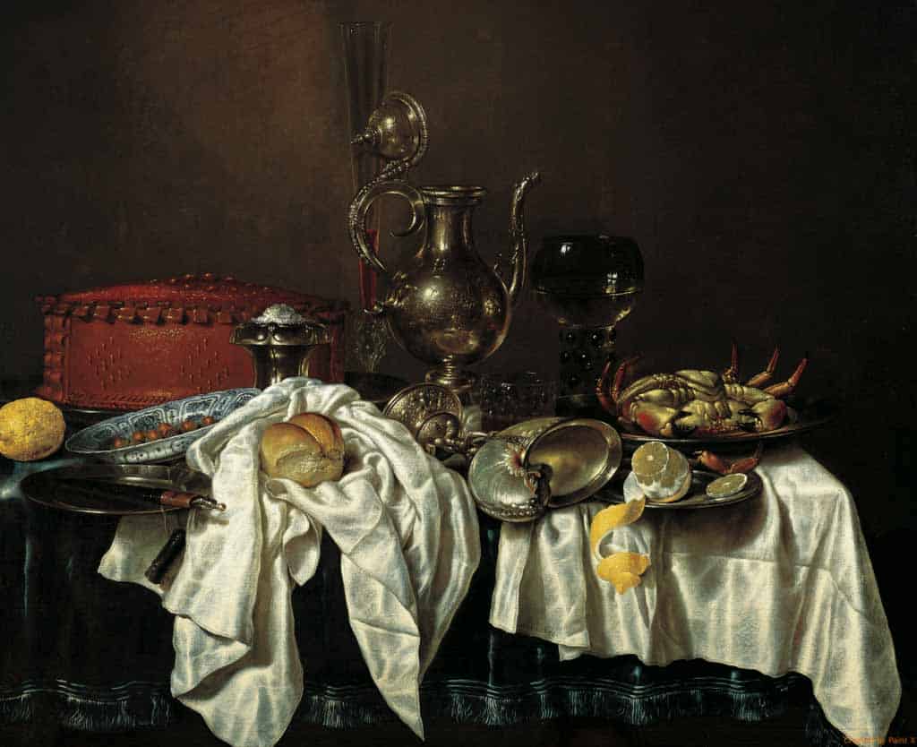 Silver teapot with lobster, lemon, bread, and vintage dishes on a draped table with dark background.