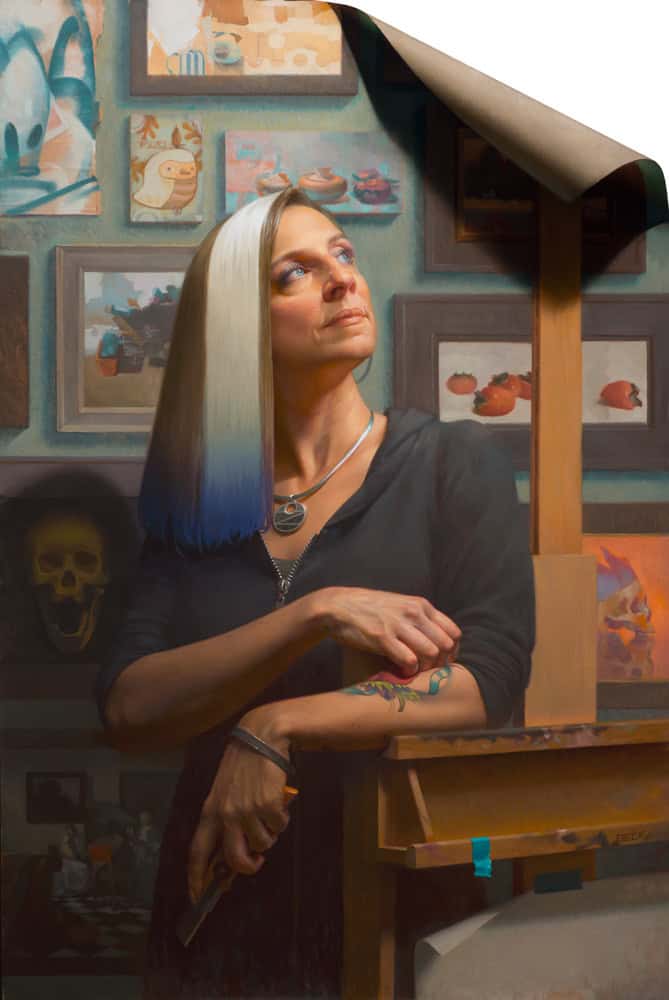 Woman painting in art studio with colorful artwork on wall behind her.