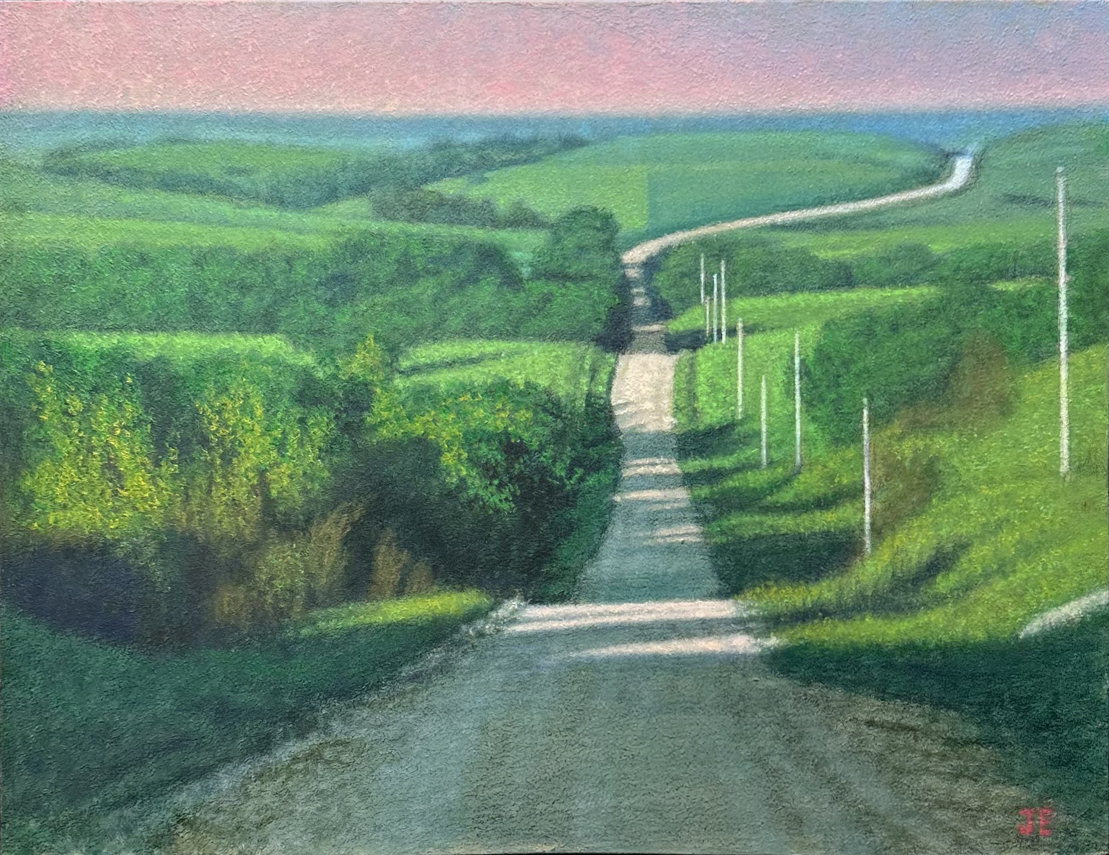 Lush green countryside landscape with a winding road, rolling hills, and vibrant foliage, capturing the beauty of rural nature and outdoor serenity.