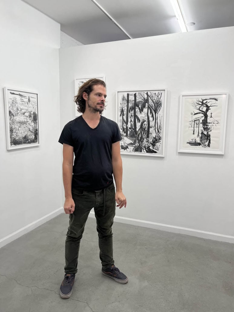 Black and white artwork displayed in a modern art gallery setting.