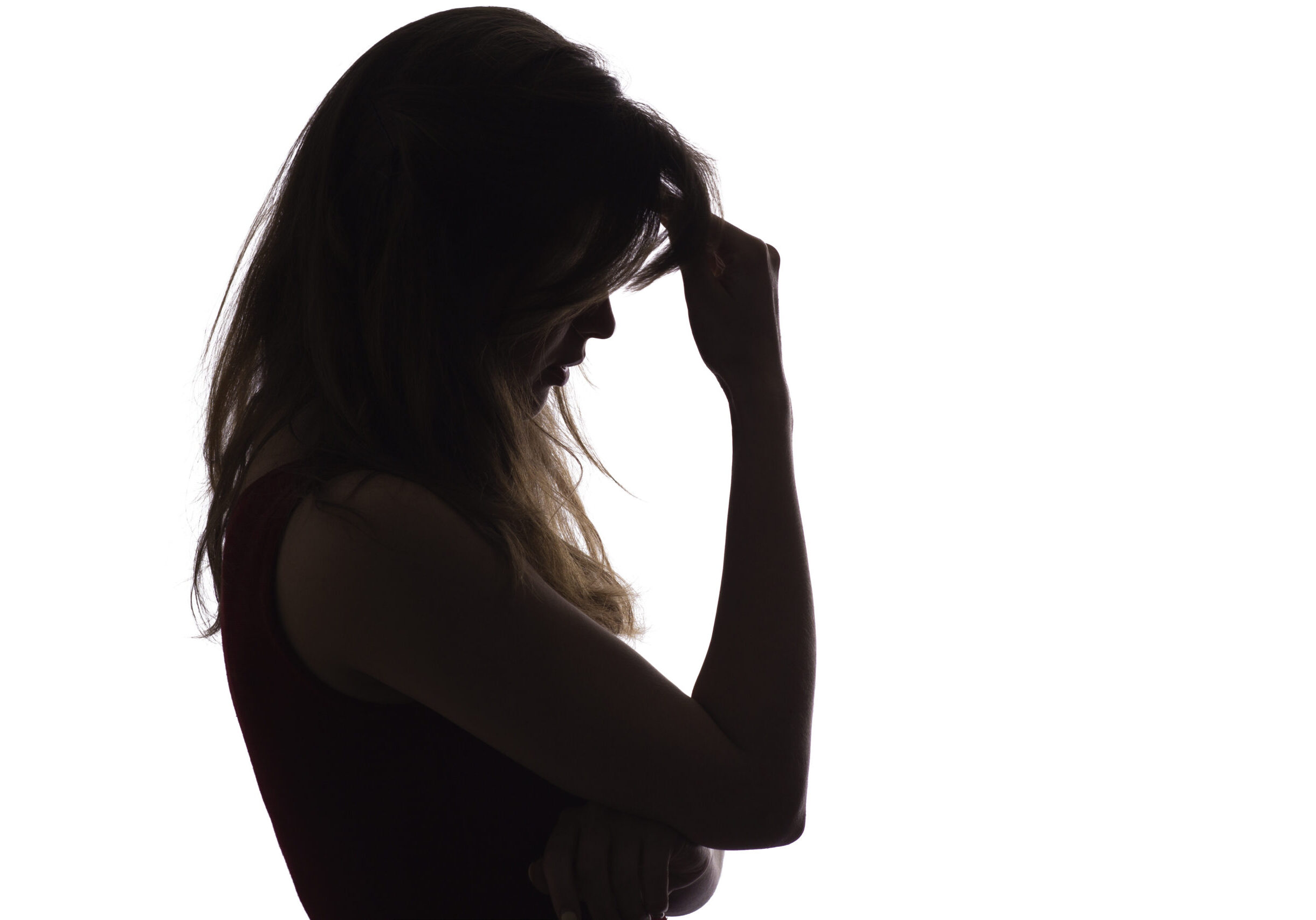 profile silhouette of a young upset woman, the girl leans her hand on her forehead and thinks about problems, the concept of difficult life situations, depression
