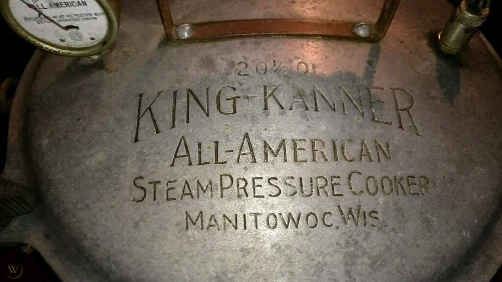 Top view of cast aluminum pressure cooker engraved with the words '20 1/2 Qt King-Kanner All-American Team Pressure Cooker Manitowoc, Wis.'