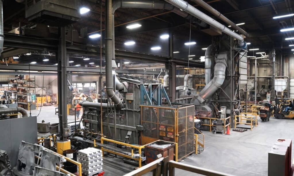 Wide view of the Wisconsin Aluminum Foundry casting facility showing equipment and vents.