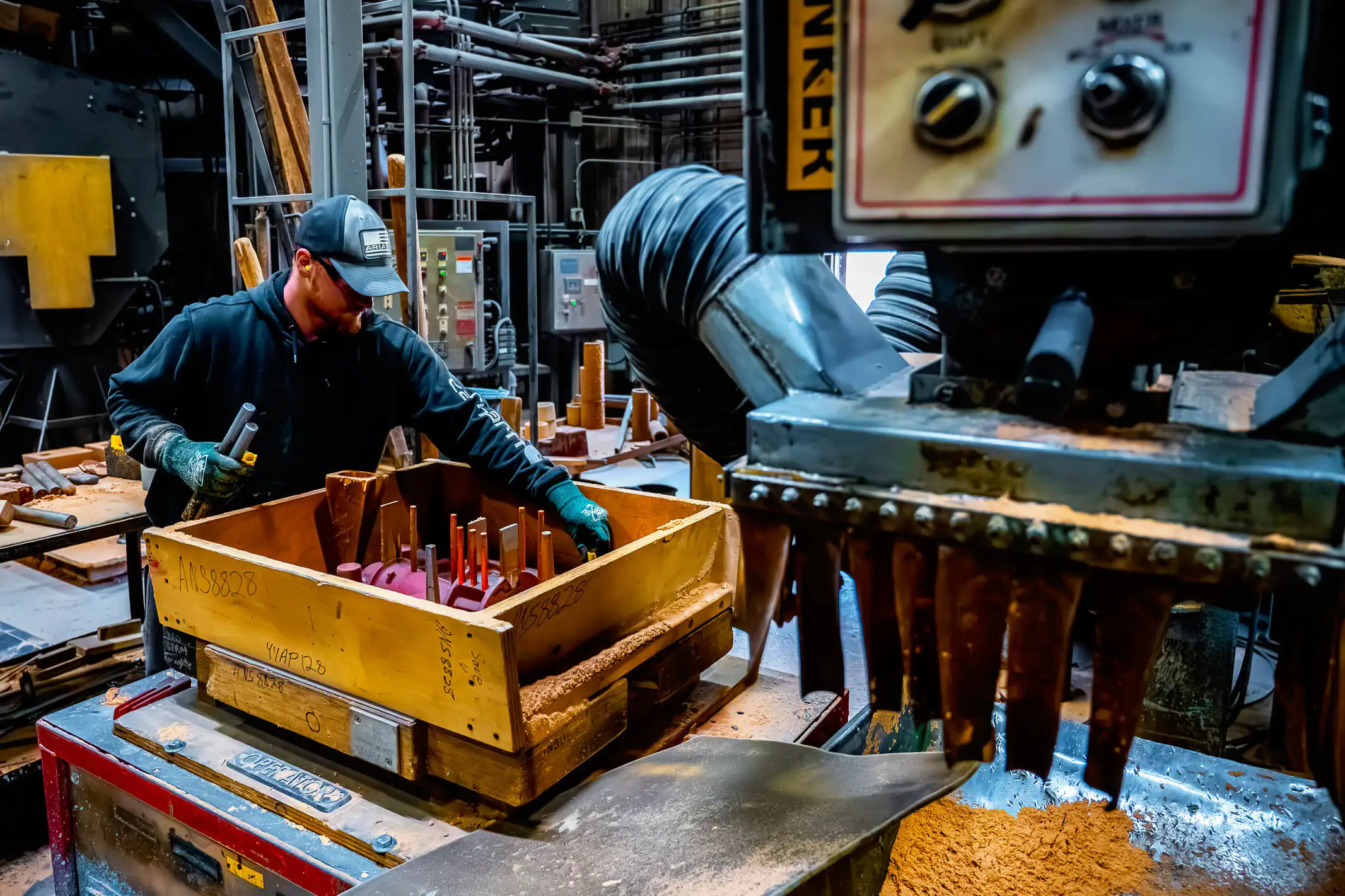 Wisconsin Aluminum Foundry molder places rods into an air set mold in preparation for pouring.