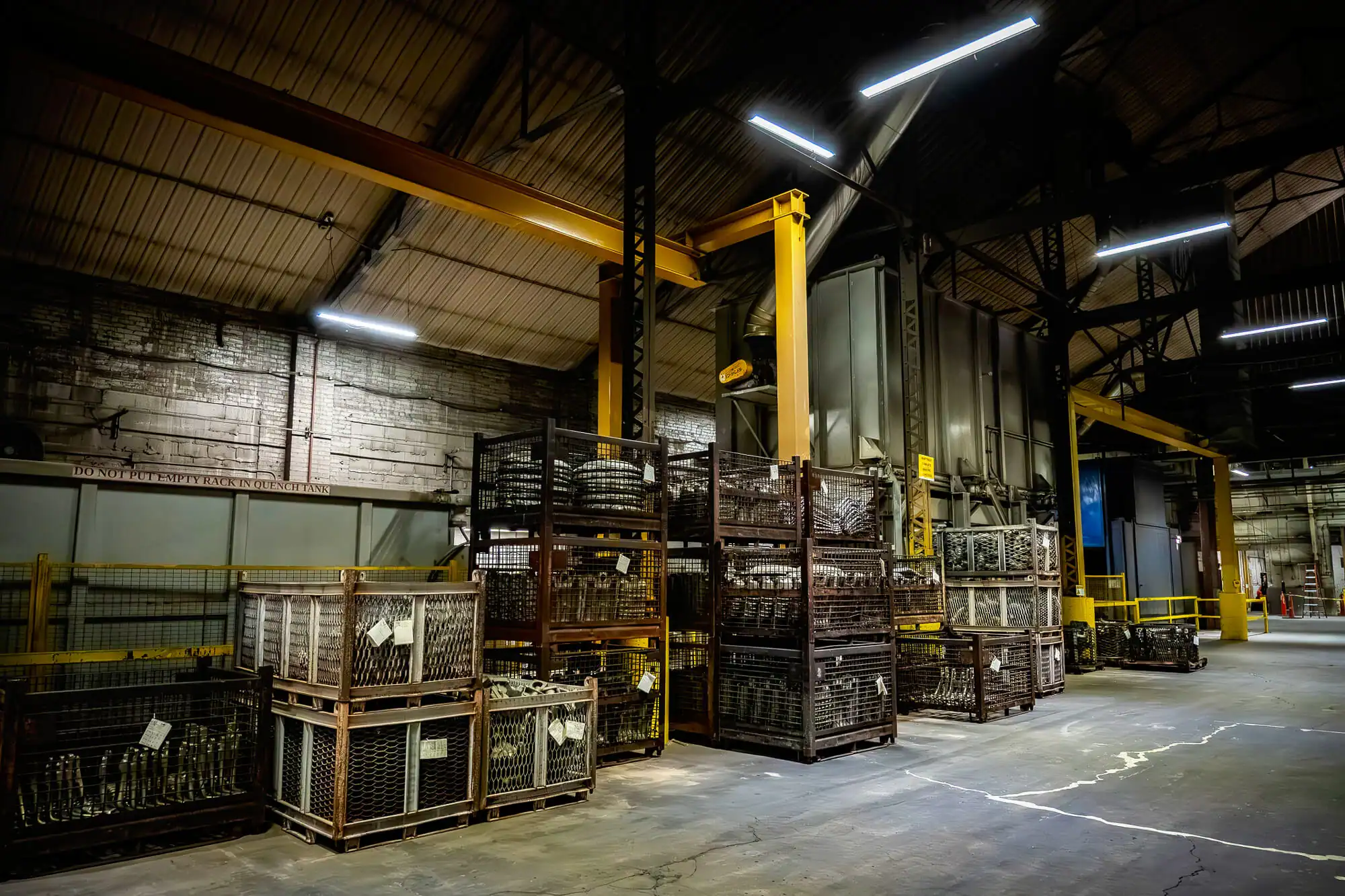 Cooling racks labeled with heat treated cast aluminum parts are stacked in a casting facility.
