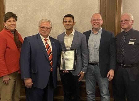 Wisconsin Technical College System (WTCS) members pose with FutureMakers Partner Award and Wisconsin Aluminum Foundry CEO Sachin Shivaram.