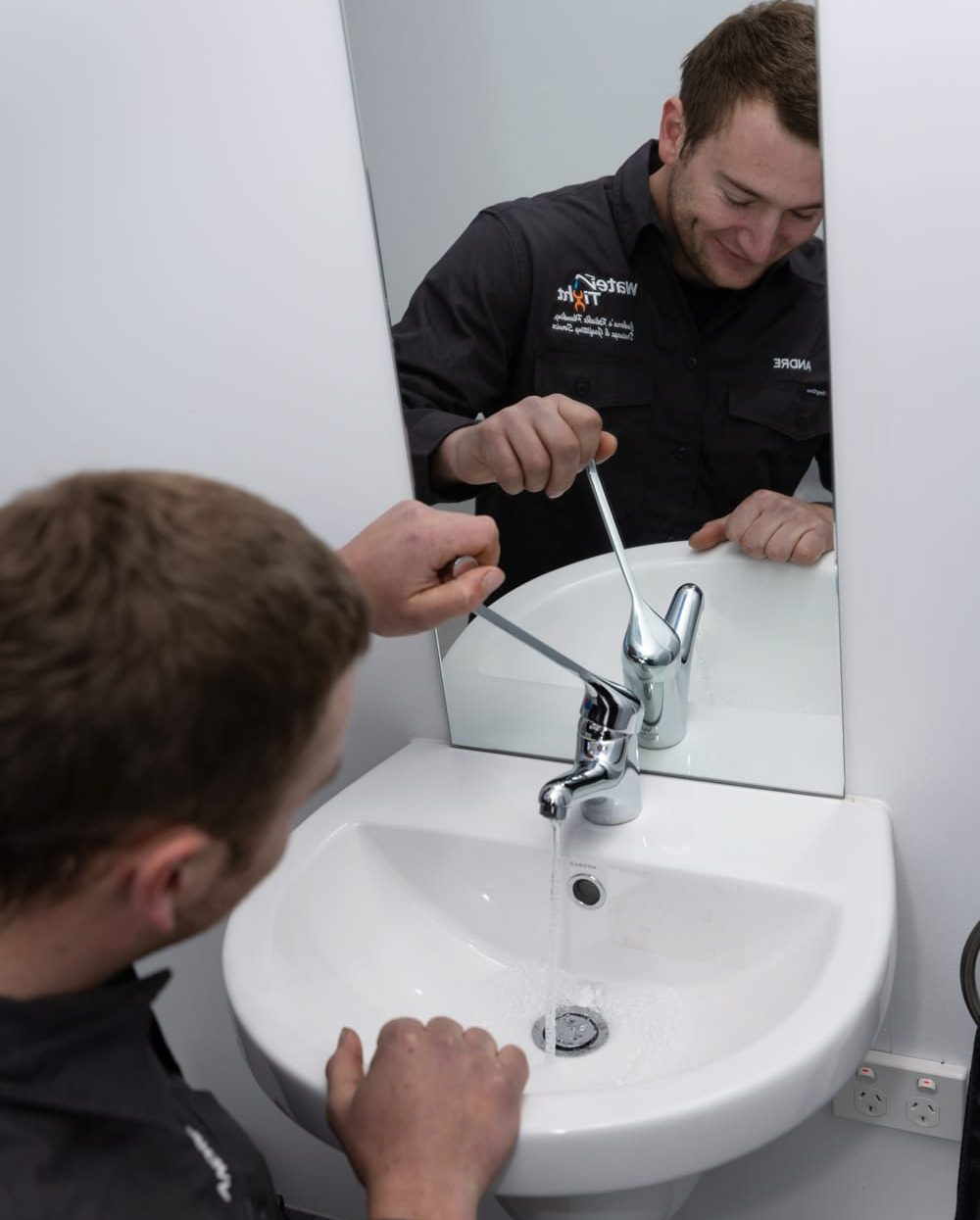 Plumber in Canberra installing a mixer tap