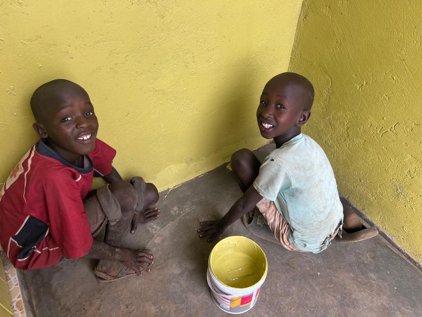 Maasai Boys Painting Toilet Wall – Washroom Project 2025
