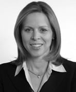 A black and white photo of a woman in a business suit.
